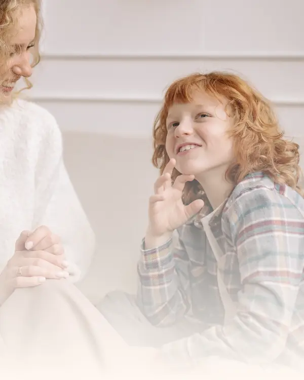 A young child smiling and engaged in a warm conversation with a therapist during a child and adolescent therapy session in Ramsey NJ and Bergen County