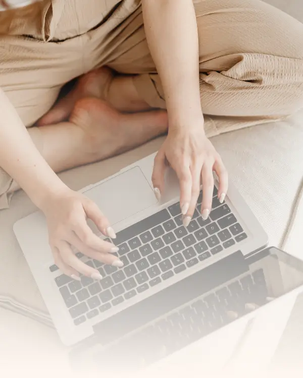 A person typing on a laptop at home, representing the comfort and accessibility of online therapy in Ramsey NJ and Bergen County